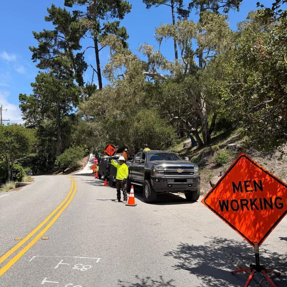 Men Working sign and cones marking a Green Angels work zone on a wooded road